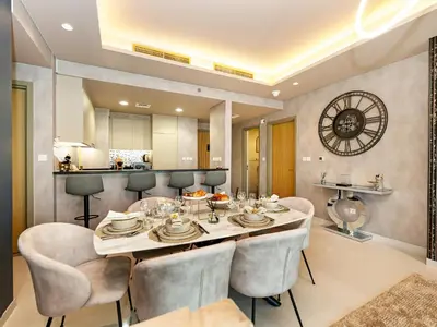 a kitchen and dining room with a table and chairs at ElysianSky Burj Khalifa Views 3 Bedroom Apartment at Paramount Hotel Midtown with 64th Floor Rooftop Pool in Dubai