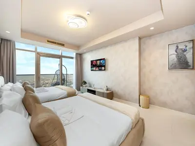 a bedroom with two beds and a large window at ElysianSky Burj Khalifa Views 3 Bedroom Apartment at Paramount Hotel Midtown with 64th Floor Rooftop Pool in Dubai
