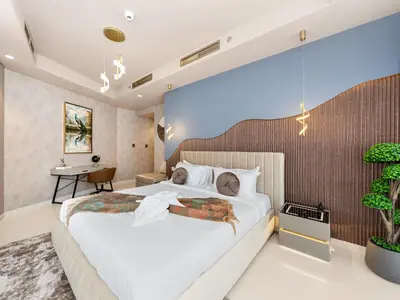 a bedroom with a large bed and a desk at ElysianSky Burj Khalifa Views 3 Bedroom Apartment at Paramount Hotel Midtown with 64th Floor Rooftop Pool in Dubai