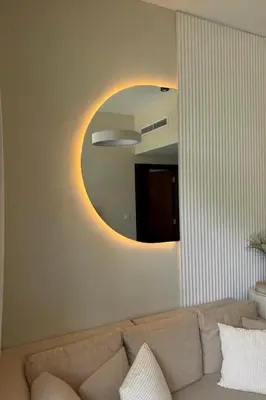 a living room with a couch and a mirror at Modern 1BR Near Burj Khalifa Business Bay Reva Apt in Dubai
