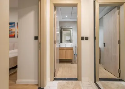 a bathroom with a sink and a mirror at Stylish 1BR Just 3 Minutes Walk to Metro in Dubai