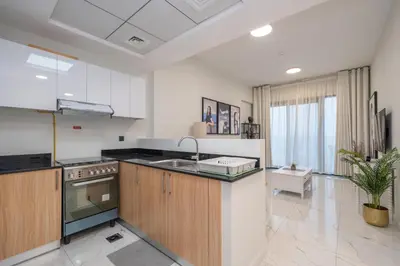 a kitchen with a sink and a counter top at Stylish 1BR Just 3 Minutes Walk to Metro in Dubai