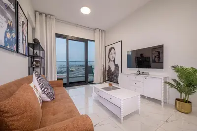 a living room with a couch and a table at Stylish 1BR Just 3 Minutes Walk to Metro in Dubai