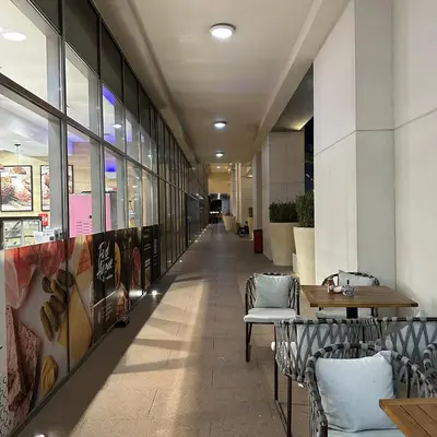 a hallway with chairs and tables in a building at Bellevue Towers Luxurious Burj Khalifa, Full Downtown & Old-town Views in Dubai