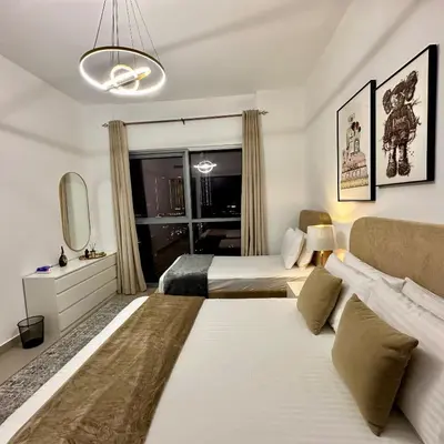 a large bedroom with two beds and a couch at Bellevue Towers Luxurious Burj Khalifa, Full Downtown & Old-town Views in Dubai