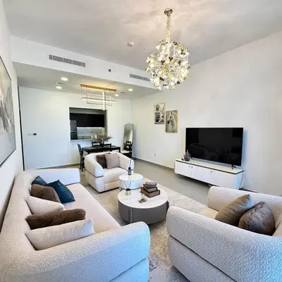 a living room with two couches and a television at Bellevue Towers Luxurious Burj Khalifa, Full Downtown & Old-town Views in Dubai