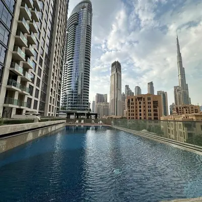a large pool of water in a city with tall buildings at Bellevue Towers Luxurious Burj Khalifa, Full Downtown & Old-town Views in Dubai
