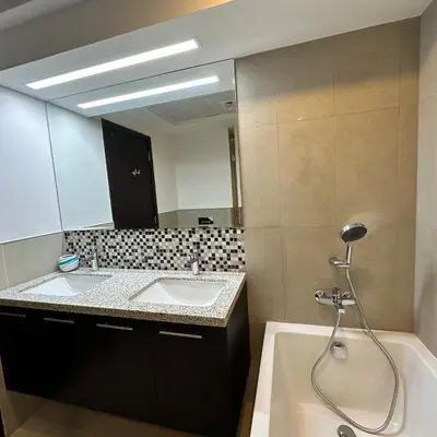 a bathroom with two sinks and a large mirror at Bellevue Towers Luxurious Burj Khalifa, Full Downtown & Old-town Views in Dubai