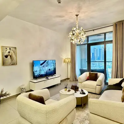 a living room with white furniture and a chandelier at Bellevue Towers Luxurious Burj Khalifa, Full Downtown & Old-town Views in Dubai