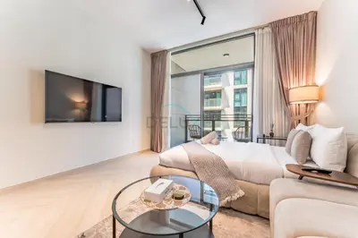 a living room with a bed and a couch at Studio Near Ras Al Khor Wildlife Sanctuary with Partial Creek Views, Just Minutes from Downtown Attractions, Wilton Park Residences, Sobha Hartland by Deluxe Holiday Homes in Dubai