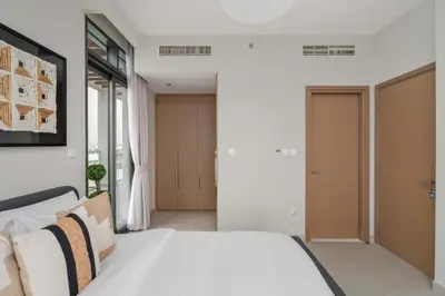 a bedroom with a white bed in a room at Elegant 3BR & City Skyline View Azizi Greenfield in Dubai