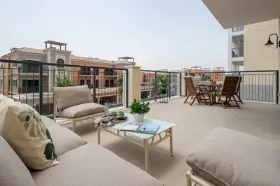a balcony with couches and a table on a building at Frank Porter - La Sirene, Jumeirah in Dubai
