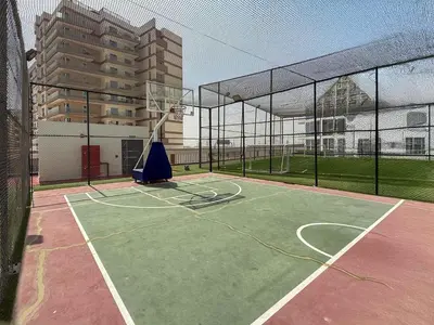 a basketball court with a net and a basketball hoop at Frank Porter - GEMZ by Danube, Al Furjan in Dubai