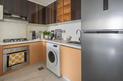 a kitchen with a dishwasher and a washer at Frank Porter - GEMZ by Danube, Al Furjan in Dubai