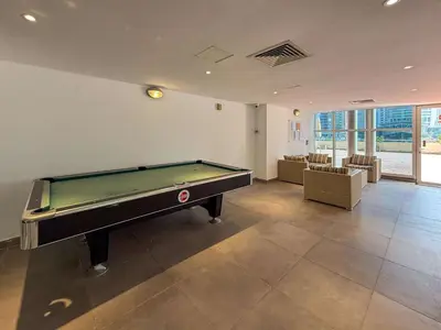 an empty room with a pool table in it at Frank Porter - Dubai Arch Tower , JLT in Dubai