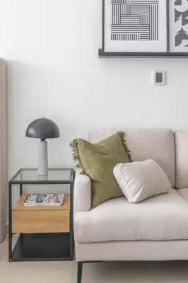 a living room with a couch and a table with a lamp at Frank Porter - Dubai Arch Tower , JLT in Dubai