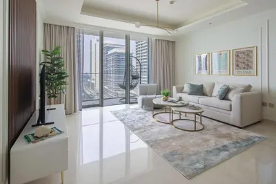 a living room with a couch and a table at Frank Porter - Palace Beach Residence Tower 1 in Dubai