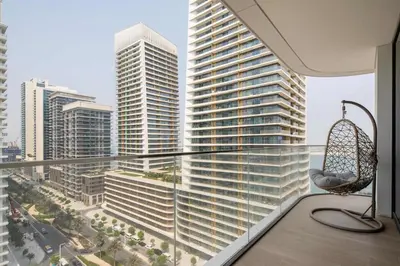 a balcony with a chair and a view of a city at Frank Porter - Palace Beach Residence Tower 1 in Dubai