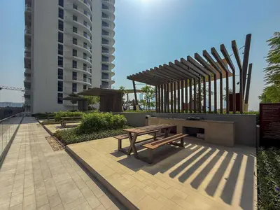 a picnic table and bench in front of a building at Frank Porter - Palace Beach Residence Tower 1 in Dubai