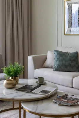 a living room with a couch and a coffee table at Frank Porter - Palace Beach Residence Tower 1 in Dubai