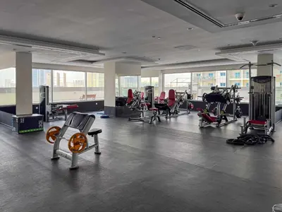 a gym with a lot of exercise equipment in a room at Frank Porter - Hera Tower in Dubai