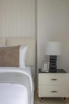 a bedroom with a bed and a lamp on a night stand at Frank Porter - Elysee III by Pantheon, JVC in Dubai