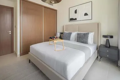 a bedroom with a bed with a table on it at Frank Porter - Palace Beach Residence Tower 2 in Dubai