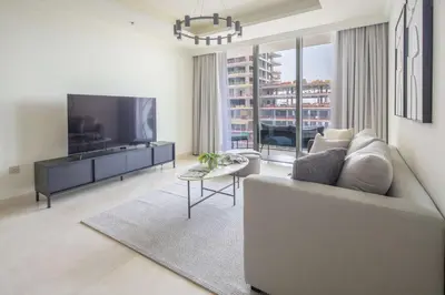a living room with a couch and a flat screen tv at Frank Porter - Palace Beach Residence Tower 2 in Dubai