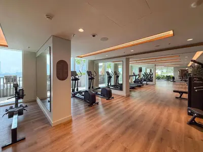 a gym with treadmills and ellipticals in a building at Frank Porter - Palace Beach Residence Tower 2 in Dubai