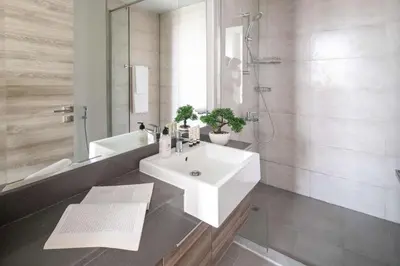 a bathroom with a white sink and a bath tub at Frank Porter - Bloom Heights Tower B in Dubai