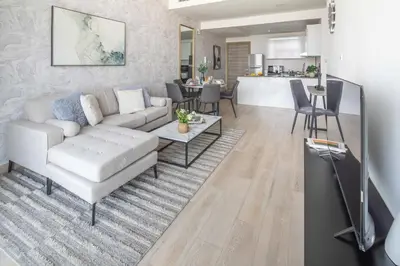a living room with a couch and a table at Frank Porter - Bloom Heights Tower B in Dubai