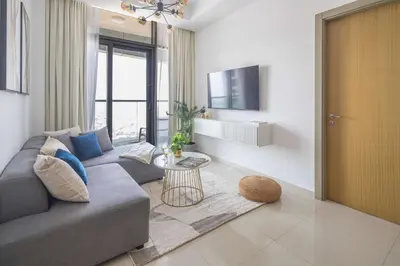 a living room with a couch and a tv at Frank Porter - Aykon City Tower C in Dubai