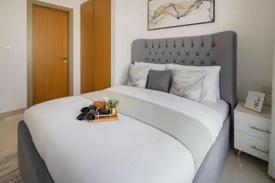 a bedroom with a large bed with a white bedspread at Frank Porter - Aykon City Tower C in Dubai
