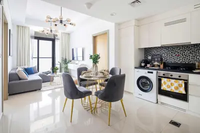 a kitchen and living room with a table and chairs at Frank Porter - Aykon City Tower C in Dubai