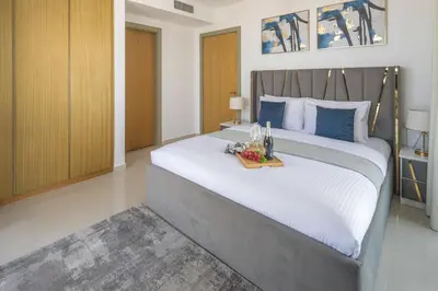 a bedroom with a large bed with a tray on it at Frank Porter - Aykon City Tower C in Dubai