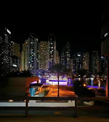a view of a city skyline at night at PHOENIXWAVES VACATIONAL HOMEs in Dubai