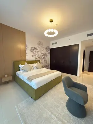 a bedroom with a large bed and a chair at Duja Tower in Dubai