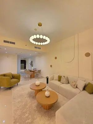 a living room with a couch and a table and chairs at Duja Tower in Dubai