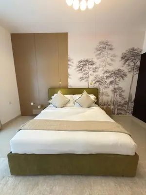 a bedroom with a large bed with white sheets and pillows at Duja Tower in Dubai