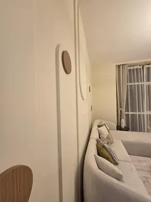 a white living room with a couch and a window at Duja Tower in Dubai