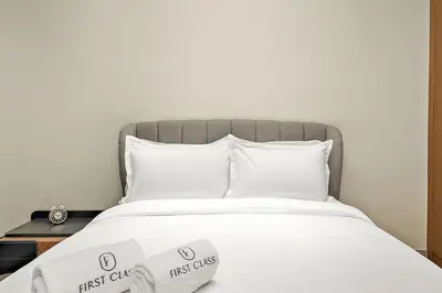 a bed with two first call signs on it at FIRST CLASS Studio Cozy Hideaway in Dubai