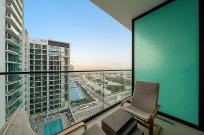 a room with a chair and a large window at FIRST CLASS Studio Cozy Hideaway in Dubai