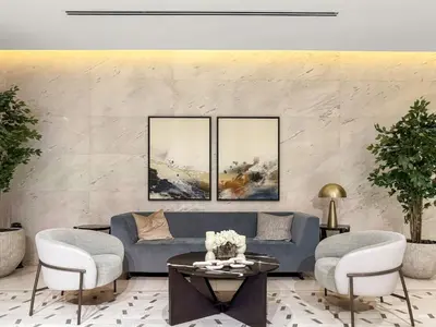 a living room with a blue couch and two chairs at Spacious 1BR for 2, 10 Min Meydan Racecourse, Pool & Gym Access in Dubai
