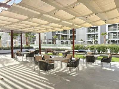 a patio with tables and chairs under a pavilion at FIRST CLASS Studio Luxury Comfort , Pool View in Dubai