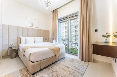 a bedroom with a large bed and a large window at Modern Apartment Near Sobha Hartland Amenities, Minutes from Ras Al Khor Wildlife Sanctuary and Downtown Dubai, Sobha Creek Vistas Tower A, Sobha Hartland by Deluxe Holiday Homes in Dubai