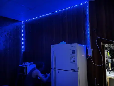 a man is sitting in front of a refrigerator at mixed room jumeirah 1, bed hostel dubai in Dubai