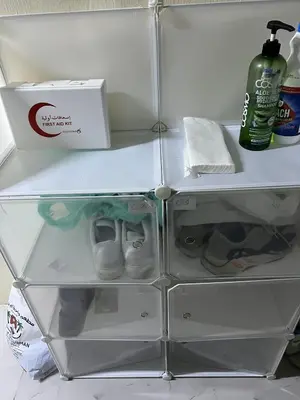 a white refrigerator with its door open with shoes at mixed room jumeirah 1, bed hostel dubai in Dubai