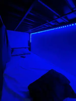 a dark room with a bed with blue lights at mixed room jumeirah 1, bed hostel dubai in Dubai