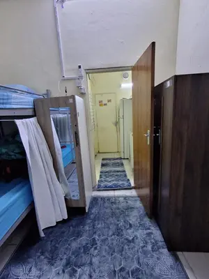 a hallway of a room with bunk beds and a door at mixed room jumeirah 1, bed hostel dubai in Dubai
