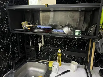 a kitchen counter with a sink and a shelf above it at mixed room jumeirah 1, bed hostel dubai in Dubai